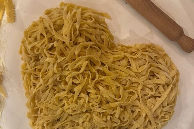 Fresh tagliatelle laid out on a floured board