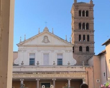 The facade and Romanesque campanile of Santa Cecilia in Trastevere, seen from its gateway